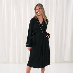 woman posing with her hand in her pocket wearing a Women's Robe in black