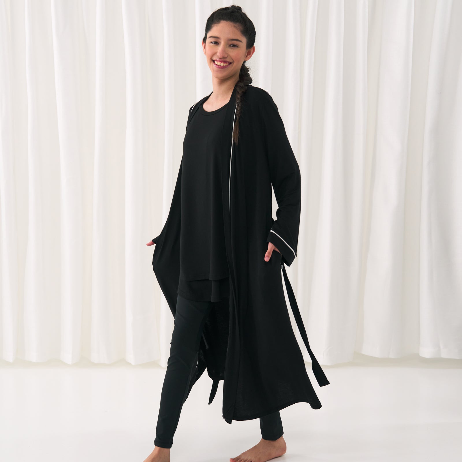 woman posing wearing a black women's nursing top with a matching women's robe