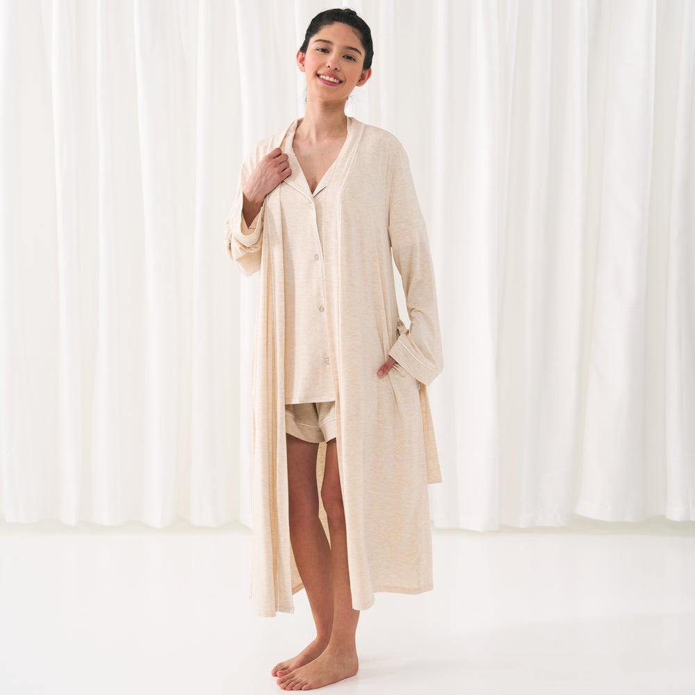 woman posing wearing a Heather Oatmeal women's pajama set paired with a matching women's robe
