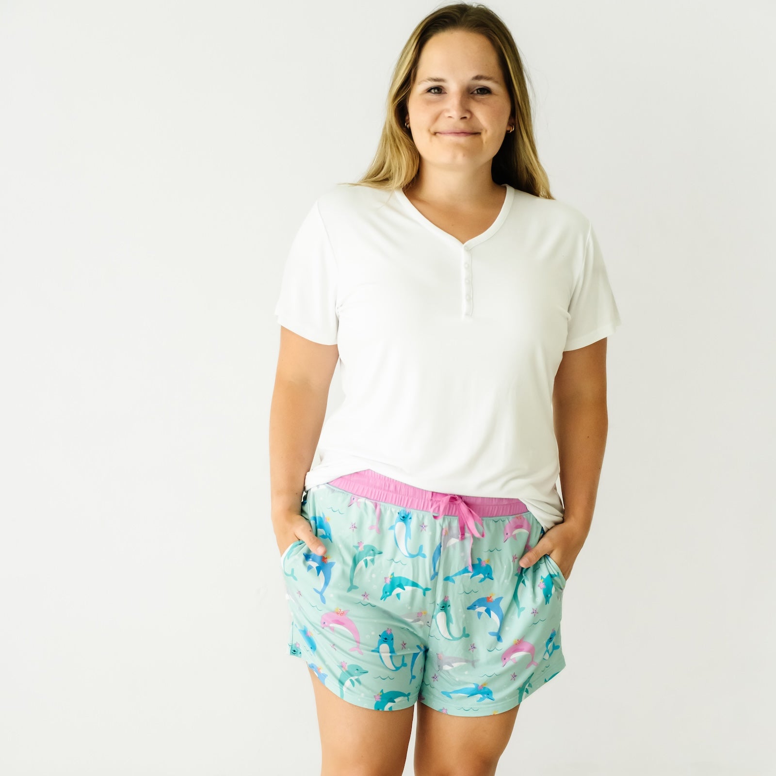 Woman wearing a Bright White women's short sleeve pajama top and coordinating pajama shorts