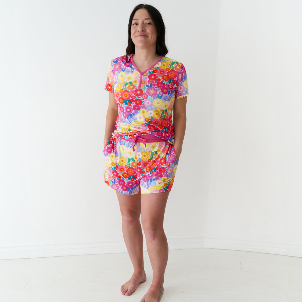 Woman wearing Rainbow Blooms women's pajama shorts and matching pajama top