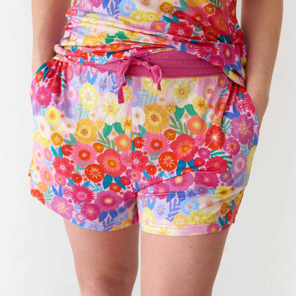 Close up image of a woman wearing Rainbow Blooms women's pajama shorts and matching top