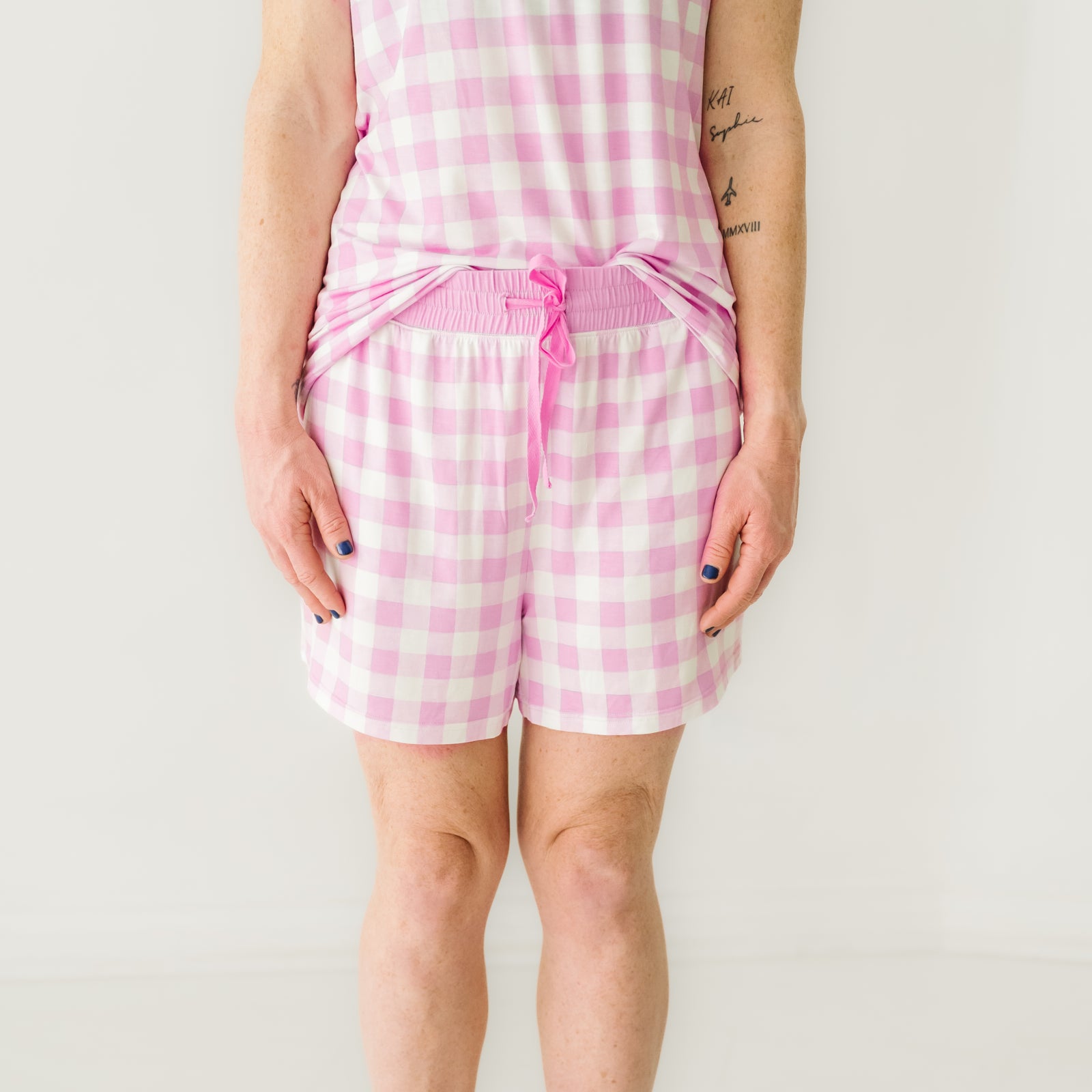 Close up image of a woman wearing Pink Gingham pajama shorts showing off the drawstring
