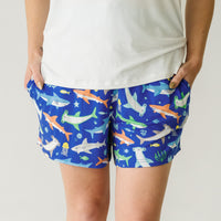 Close up image of a woman wearing Rad Reef women's pajama shorts and coordinating pajama top