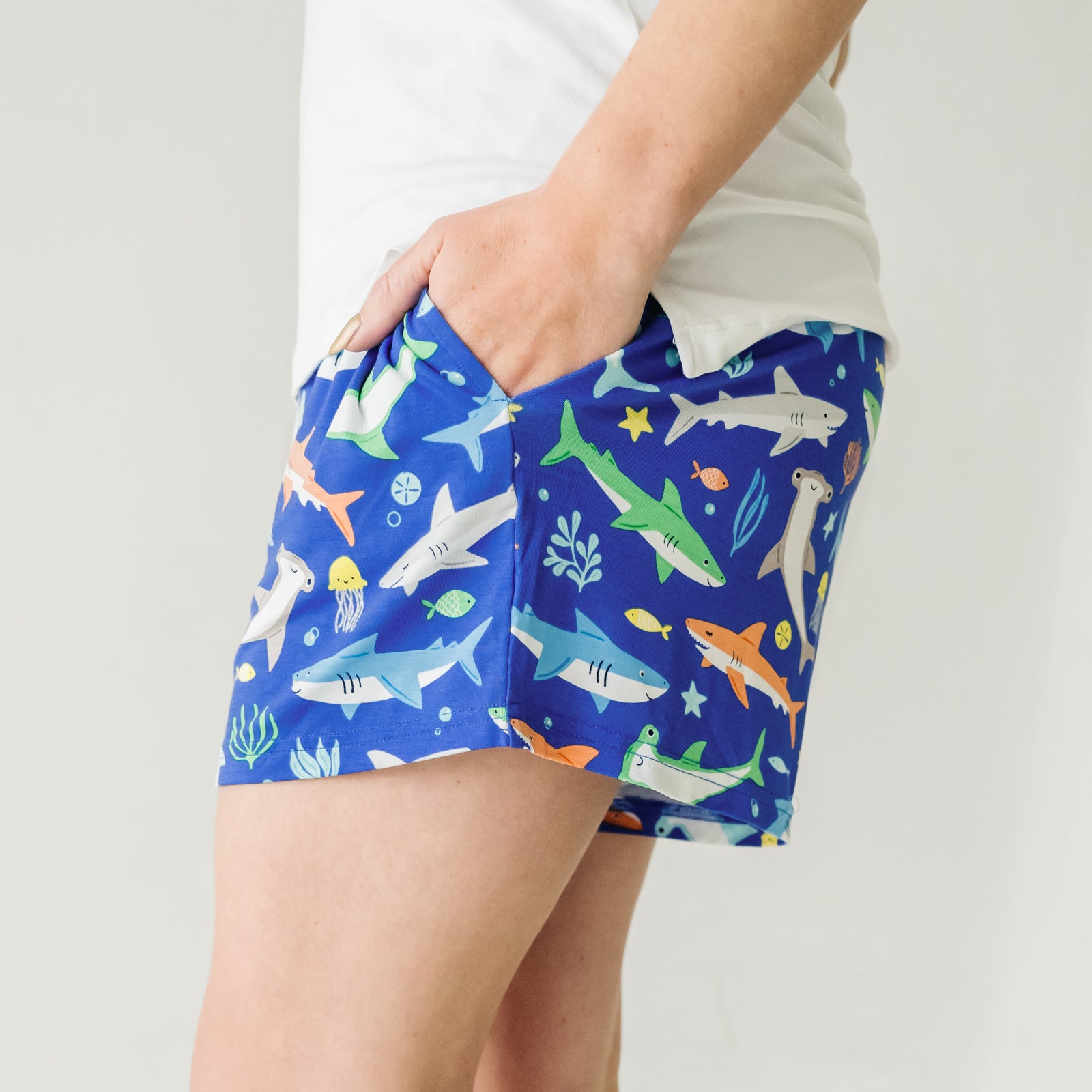 Close up side view image of a woman wearing Rad Reef women's pajama shorts and coordinating top