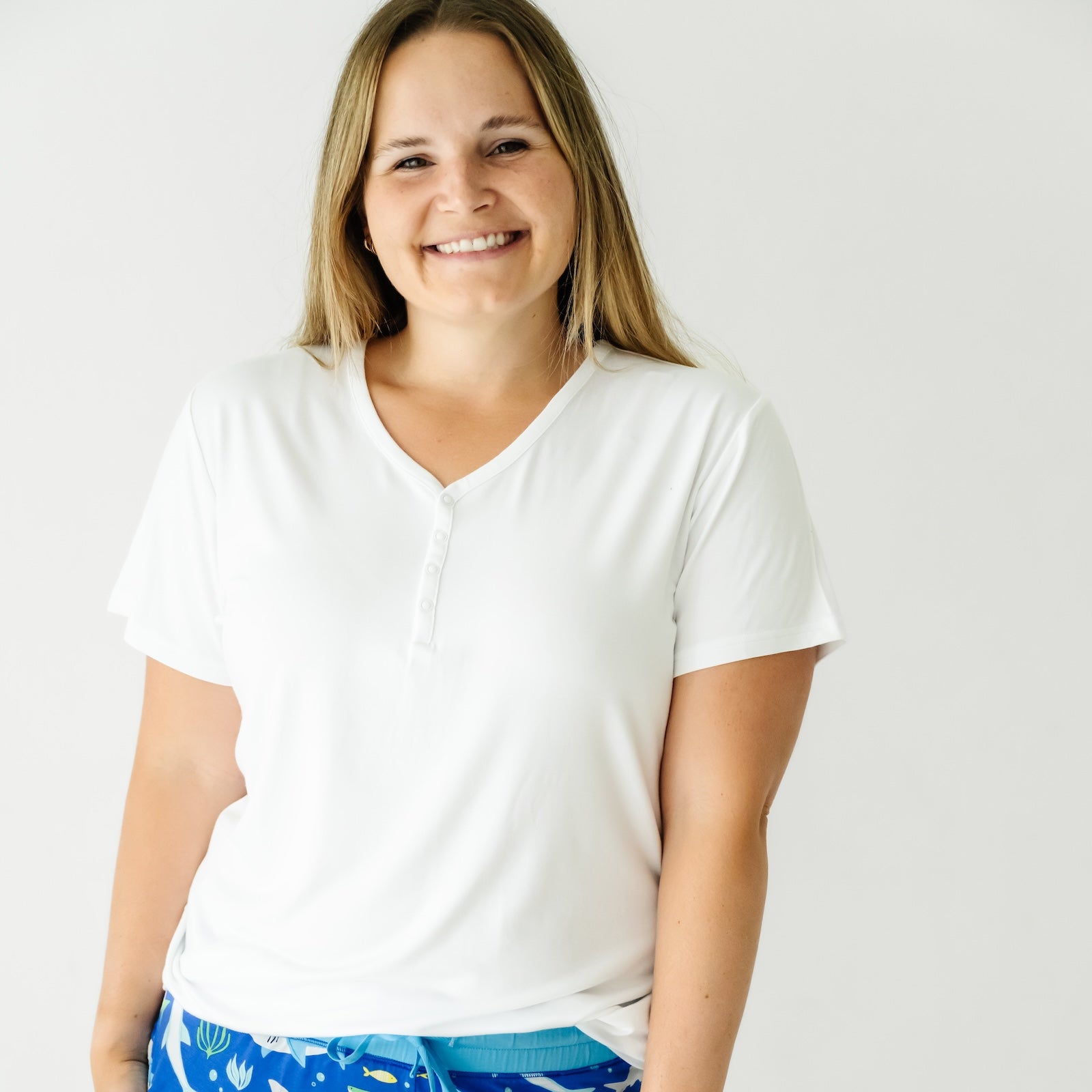 Close up image of a woman wearing a Bright White women's short sleeve pajama top