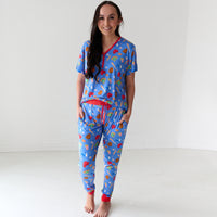 Woman wearing women's Blue All Stars pajama pants and matching women's pajama top