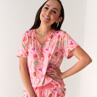 Close up image of a woman wearing Pink All Stars women's pajama top