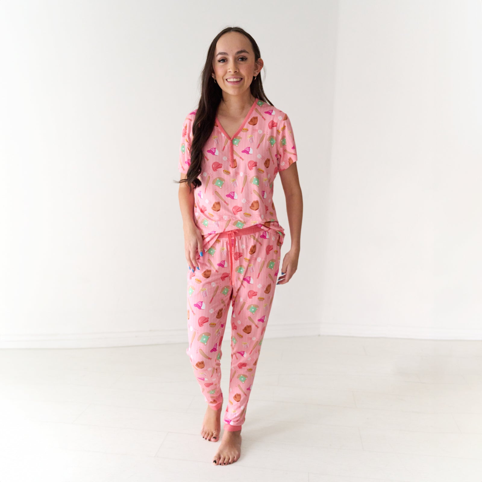 Woman wearing women's Pink All Stars pajama pants and matching women's pajama top
