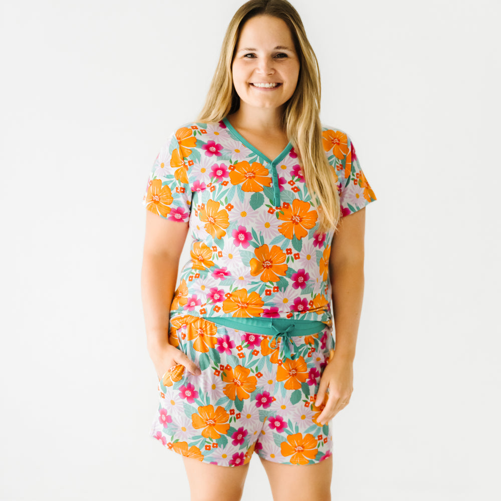 Woman wearing Beachy Blooms printed women's pajama shorts and matching women's pajama top.