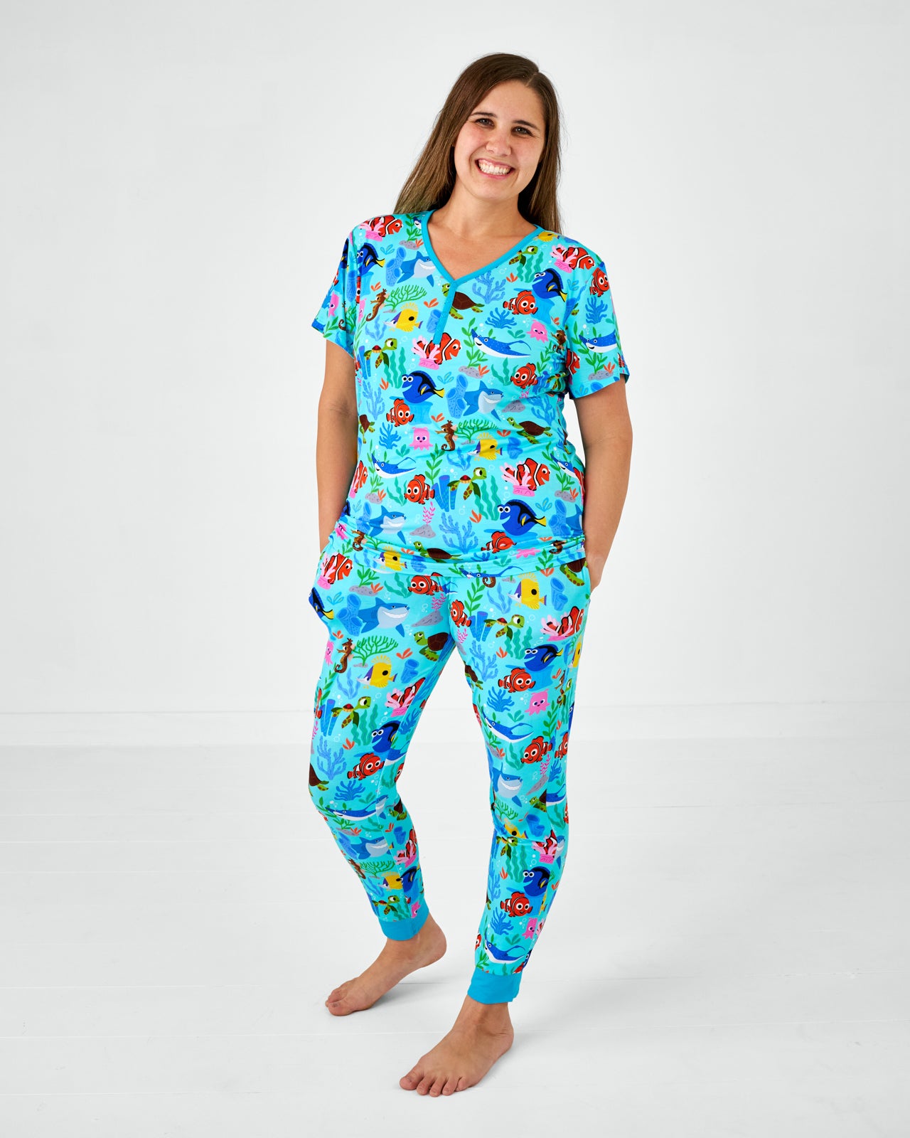 Standing woman wearing the Disney Nemo's Reef Women's Short Sleeve Pajama Top with matching pants