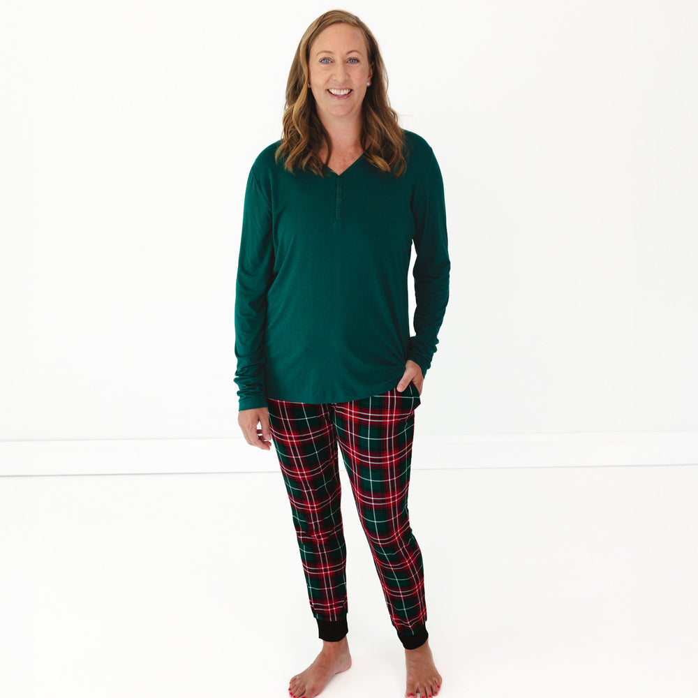 Smiling female model wearing the Emerald Women's Pajama Top and Fireside Plaid Women's Pajama Pants