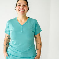 Close up image of a woman wearing a Glacier Turquoise women's short sleeve pajama top