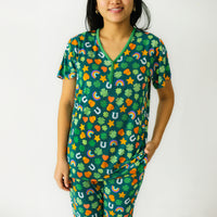 Close up image of a woman wearing a women's Lucky printed pajama top and matching pajama pants