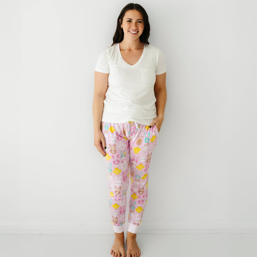 Click to see full screen - Woman wearing Pink Pastel Parade women's pajama pants paired with a coordinating Bright White women's pocket tee
