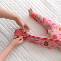 Mother folding over the cuffs on a Pink All Stars zippy