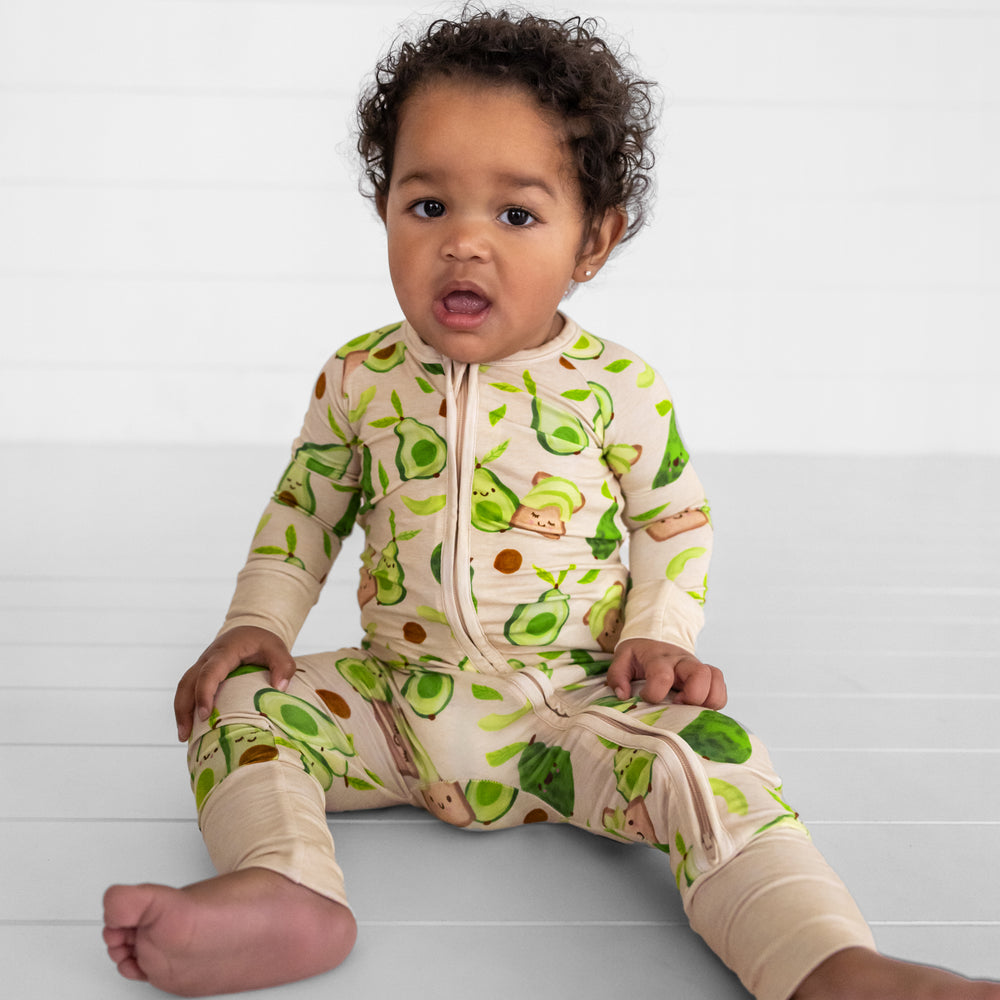 Image of a child sitting wearing an Avocado Toast zippy