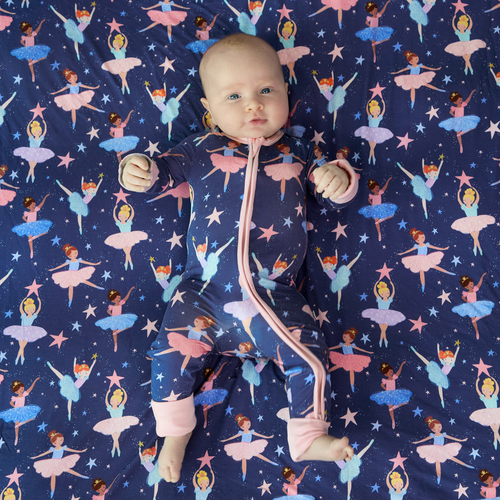 Image of a baby wearing a Twilight Ballet zippy on top of a matching Twilight Ballet cloud blanket