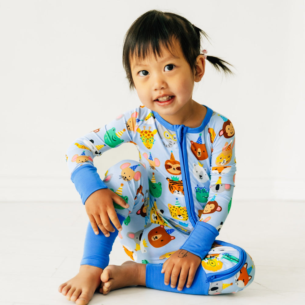 Child sitting wearing a Blue Party Pals zippy