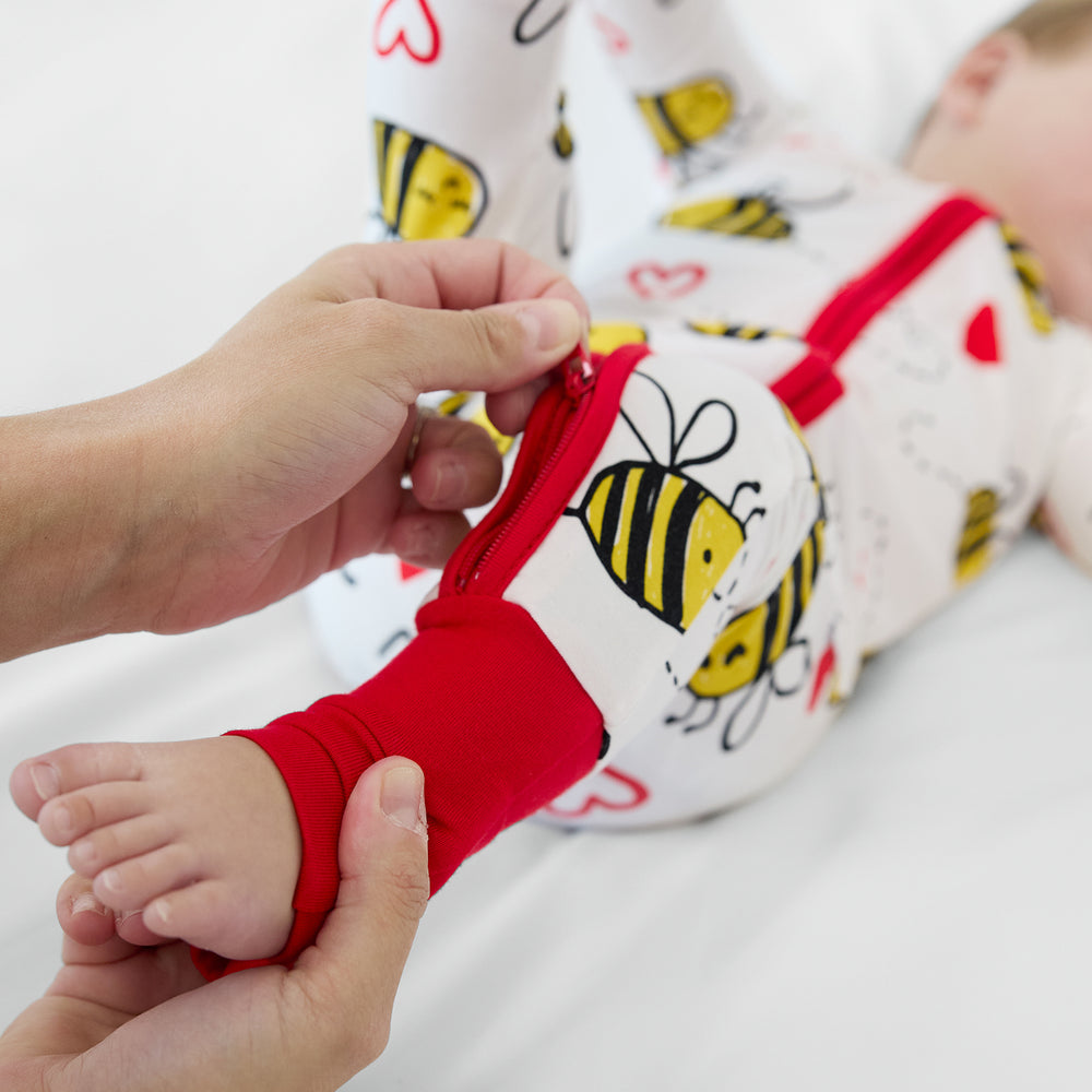 Close up image of a woman zipping up the leg on a bee Mine zippy