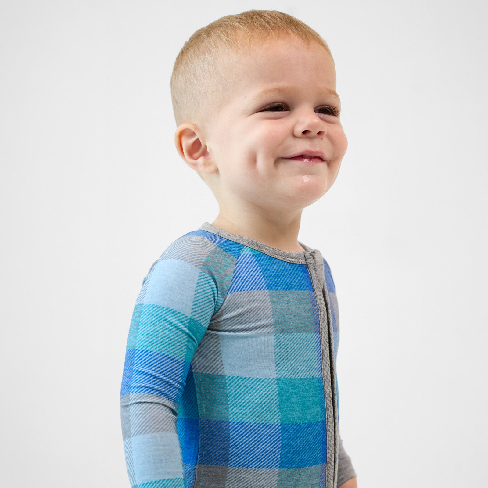 close up profile image of a child wearing an Arctic Plaid zippy