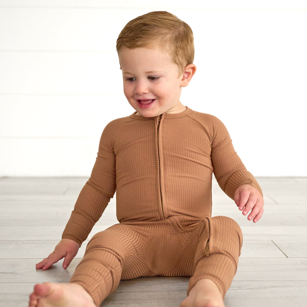 Boy sitting while wearing the Caramel Ribbed Zippy