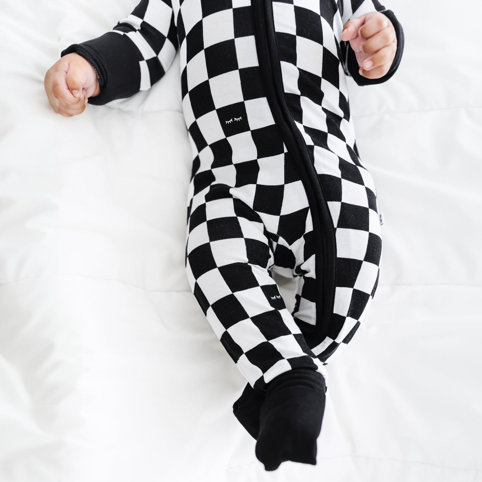 close up image of a child wearing Cool Checks zippy showing off the folded feet cuffs