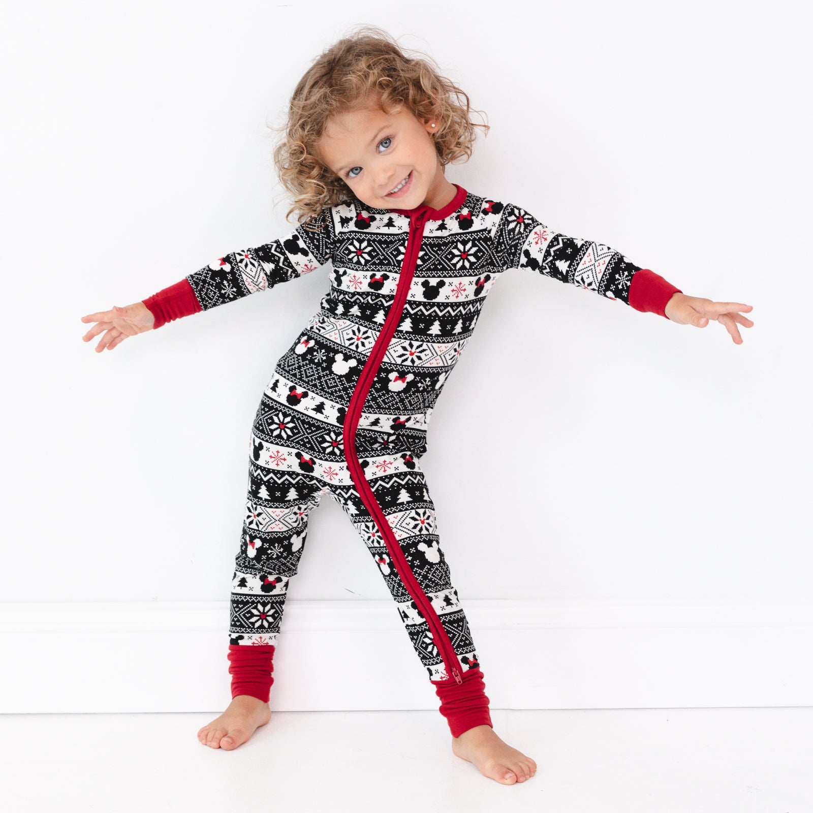 Child posing wearing a Mickey Fair Isle zippy