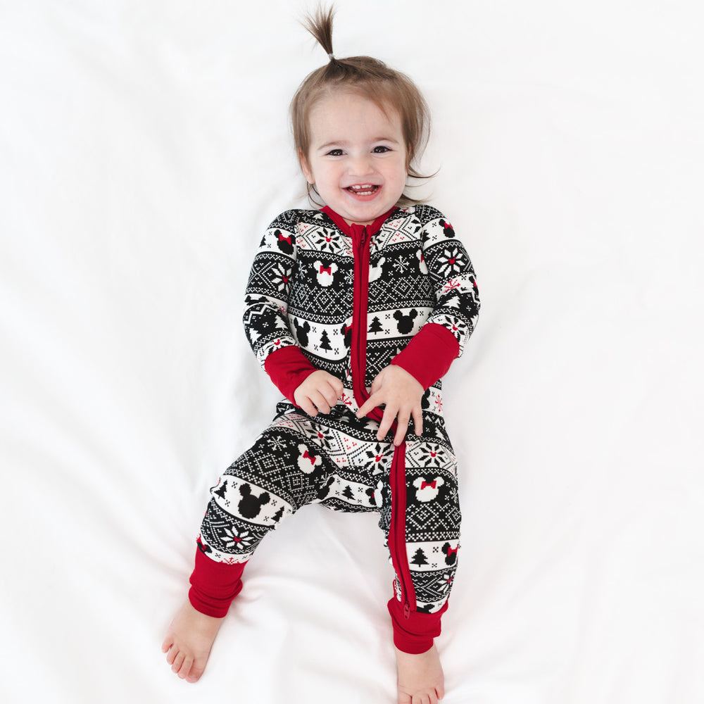 Child laying on a bed wearing a Mickey Fair Isle zippy