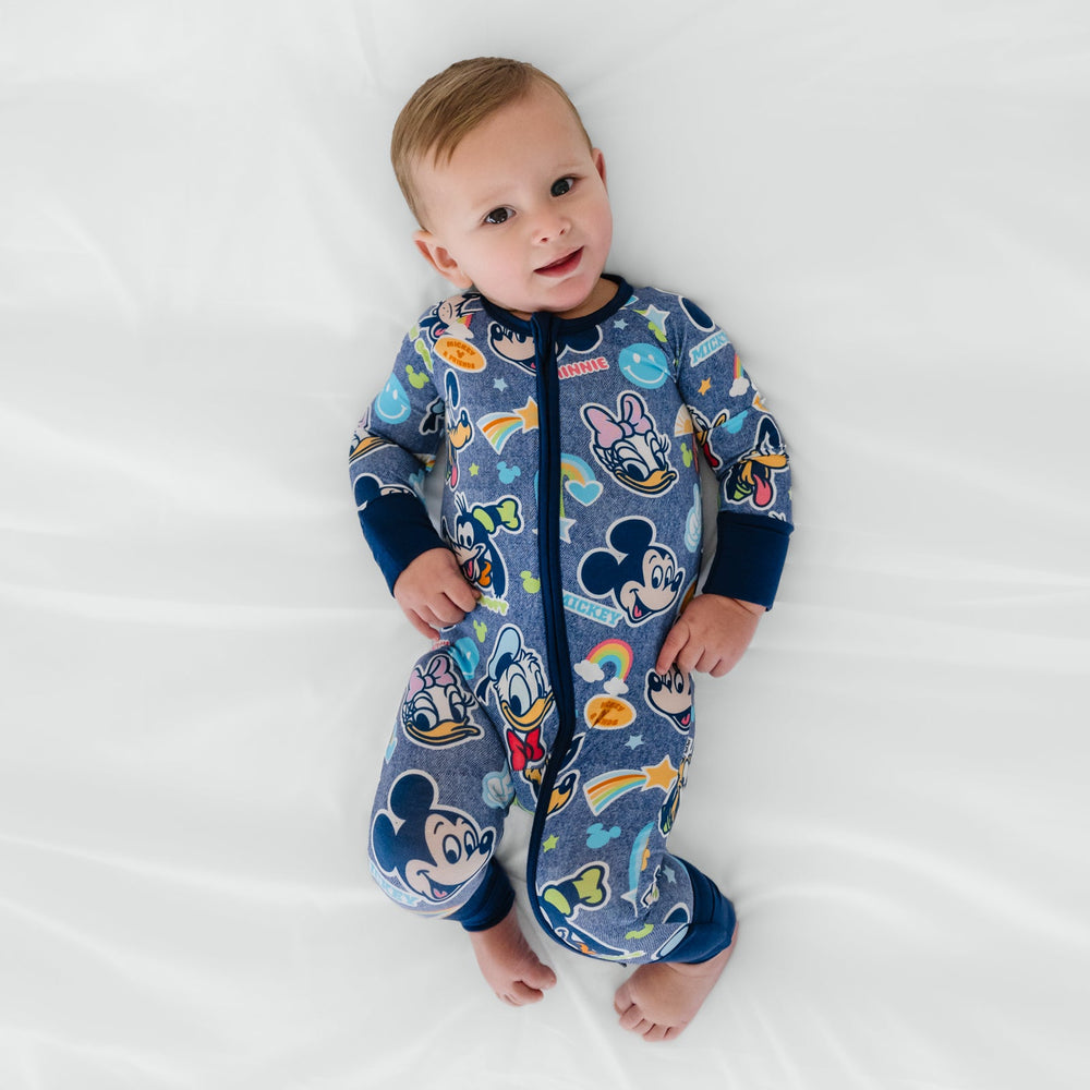 Baby laying on a bed wearing Disney Mickey's Clubhouse bamboo pajamas