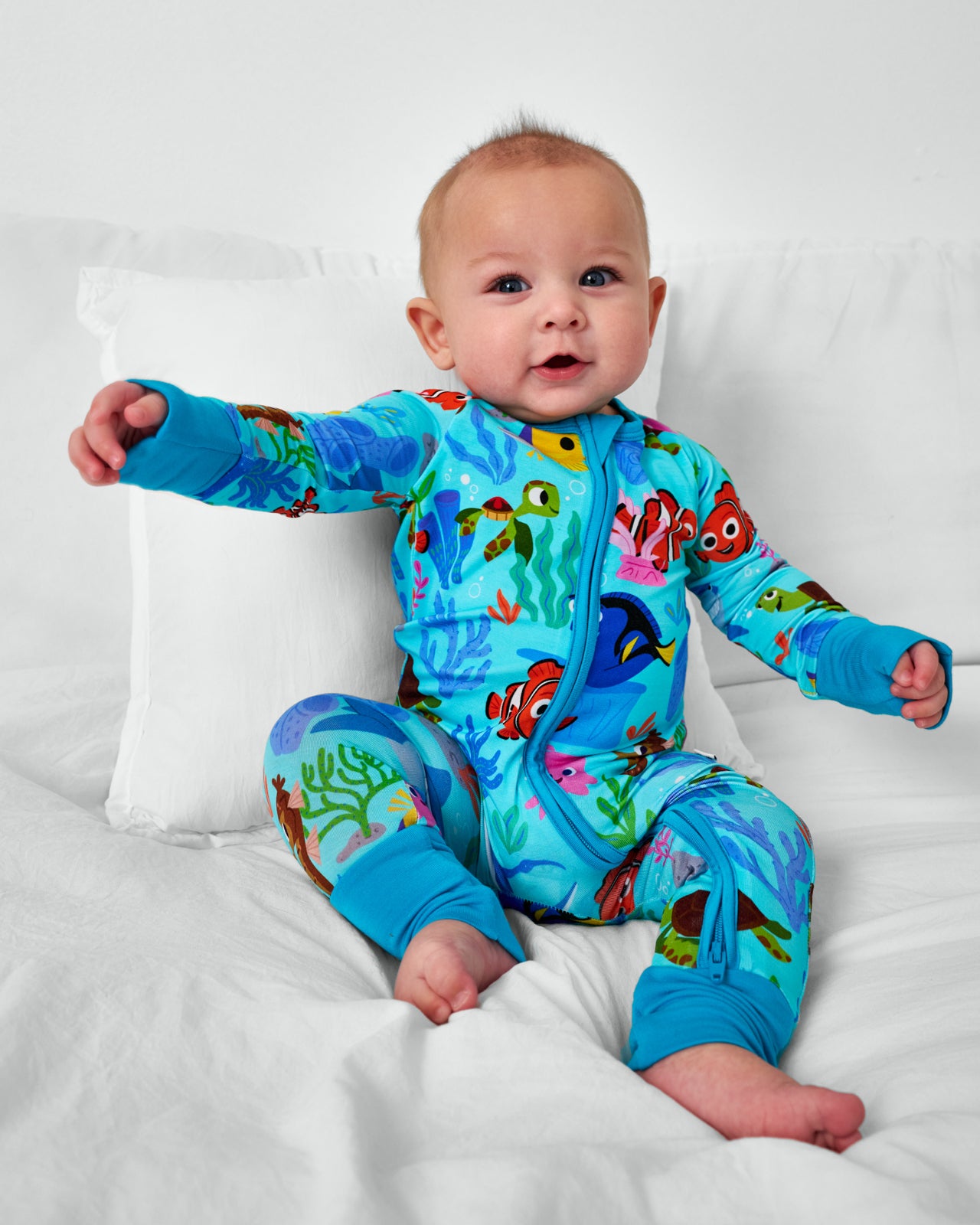 Sitting child wearing the Disney Nemo's Reef bamboo Zippy