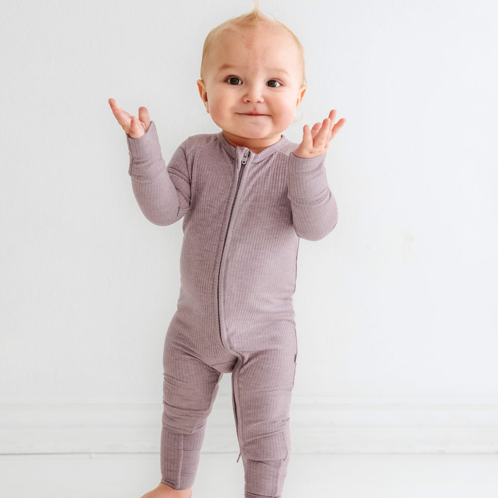 Click to see full screen - Child posing wearing a Heather Smokey Lavender Ribbed zippy