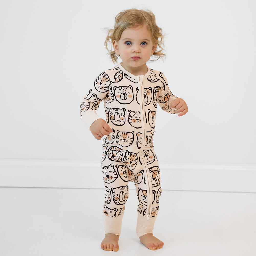 Image of a child wearing a Lions, Tigers, and Bears zippy