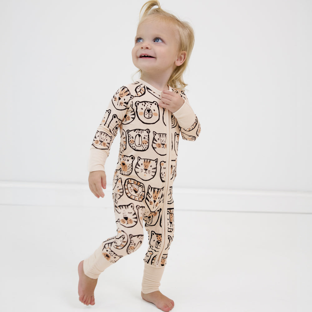 Image of a child posing wearing a Lions, Tigers, and Bears zippy