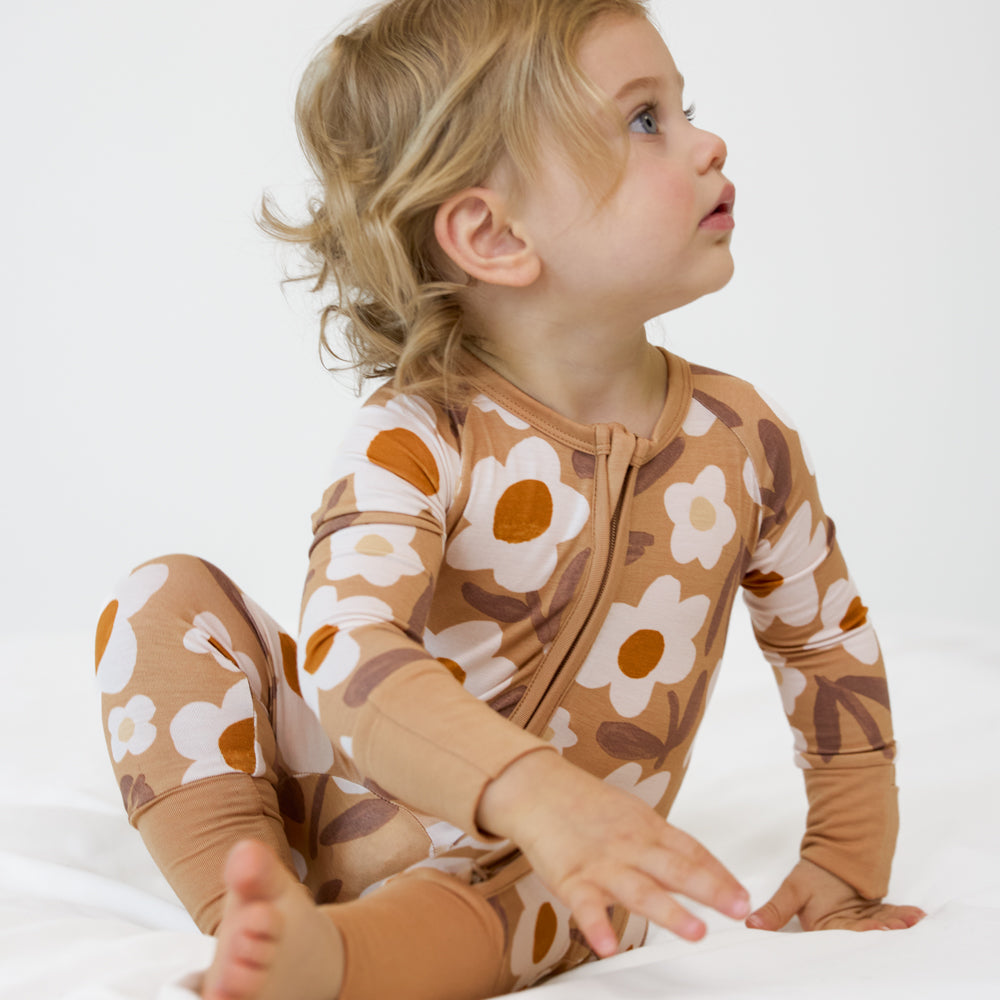 Image of a child sitting and posing wearing a Daisy Daydream zippy