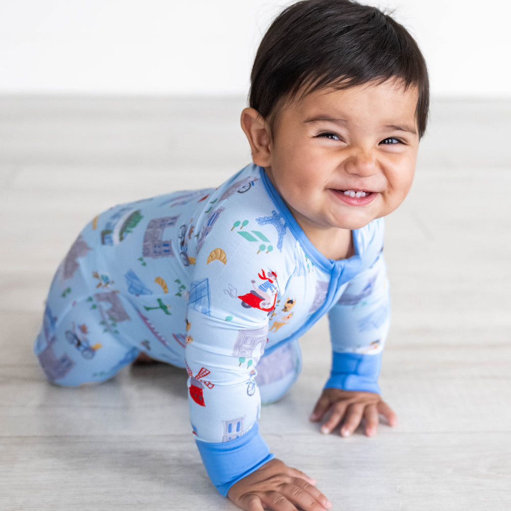 Baby crawling while wearing the Blue Weekend in Paris Zippy