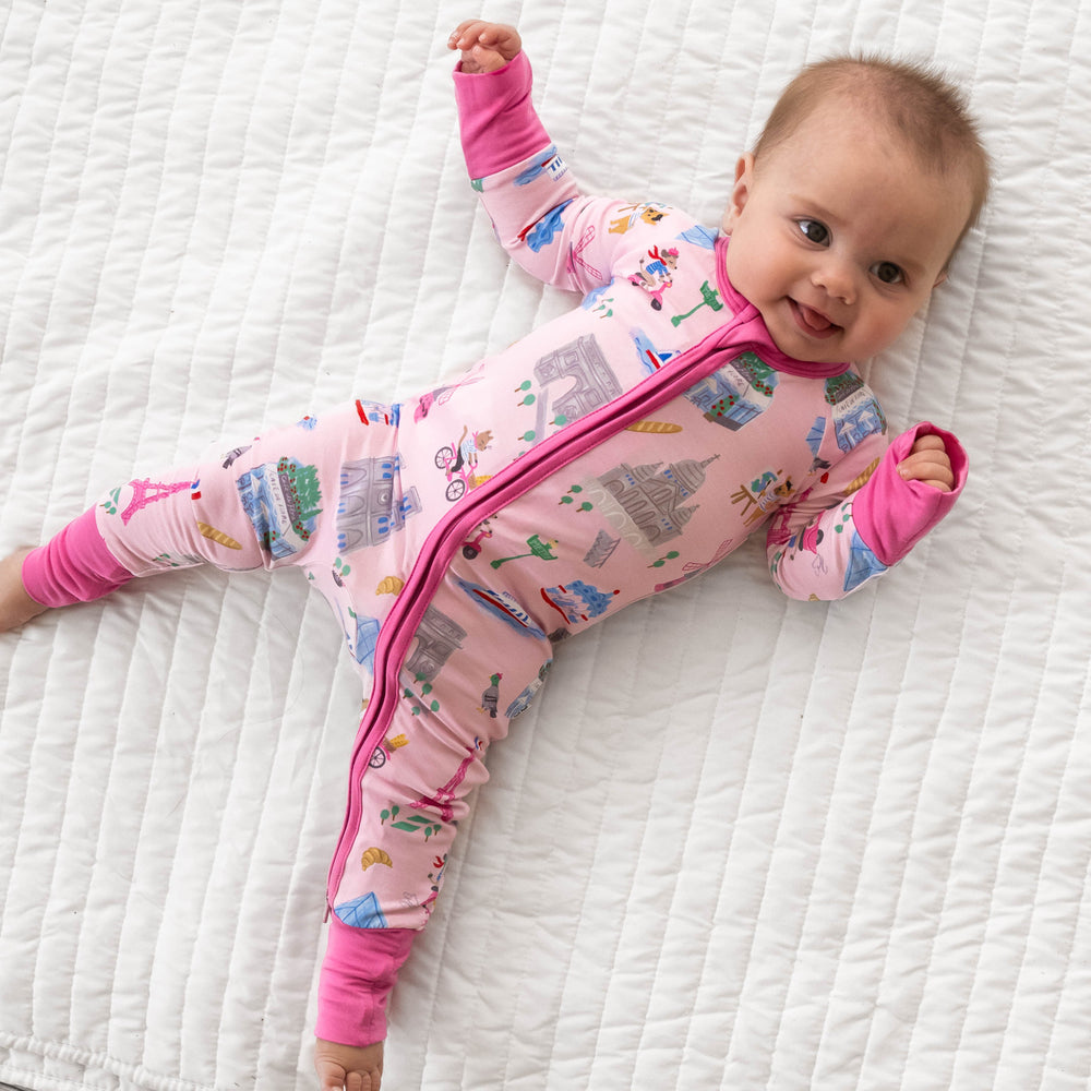 Top view image of baby laying down and wearing the Pink Weekend in Paris Zippy