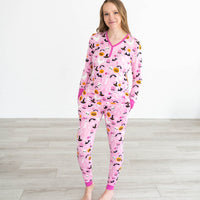 Female model wearing the Pink Glowing Ghouls Women's Pajama Top & Pants