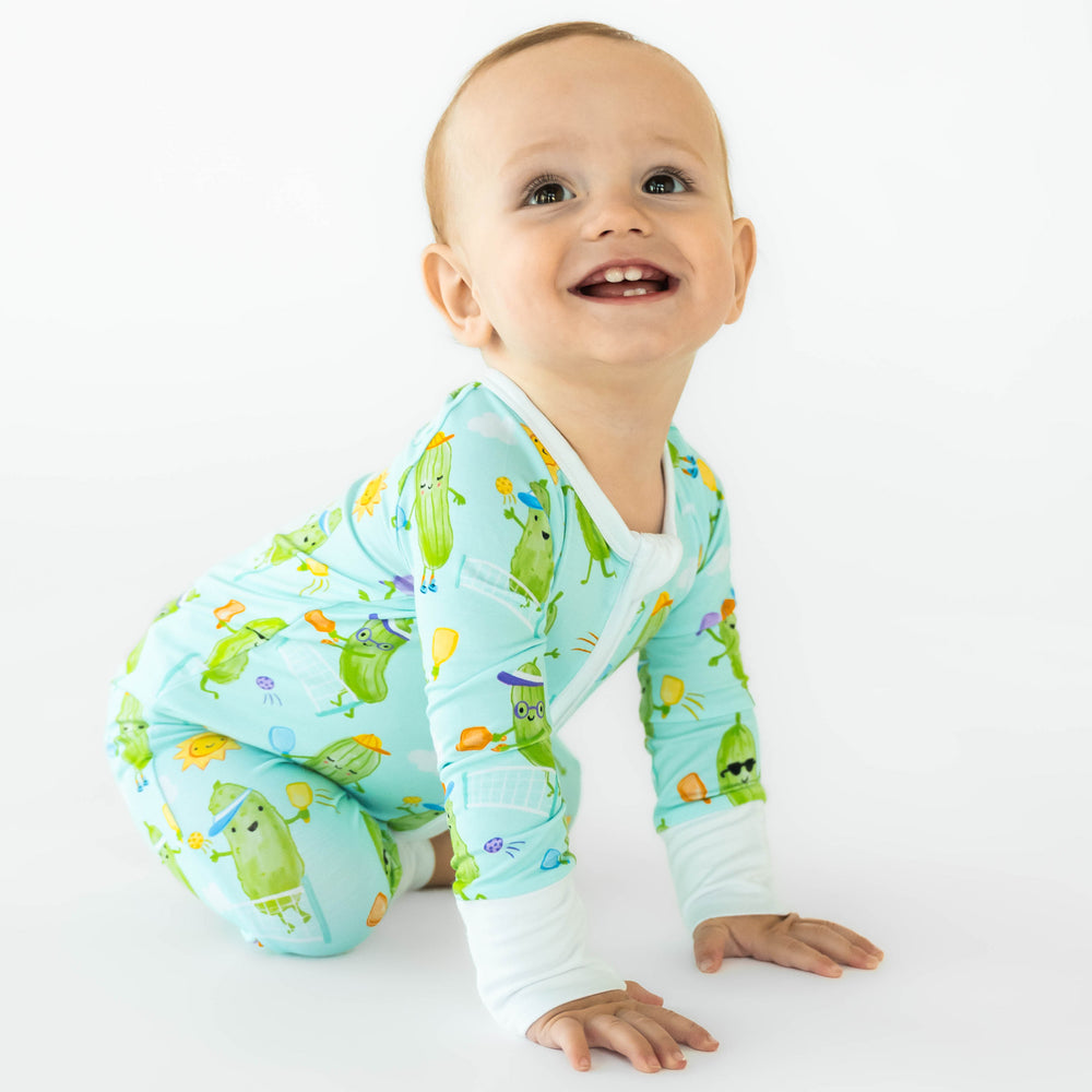 Baby crawling while wearing the Pickle Power Zippy