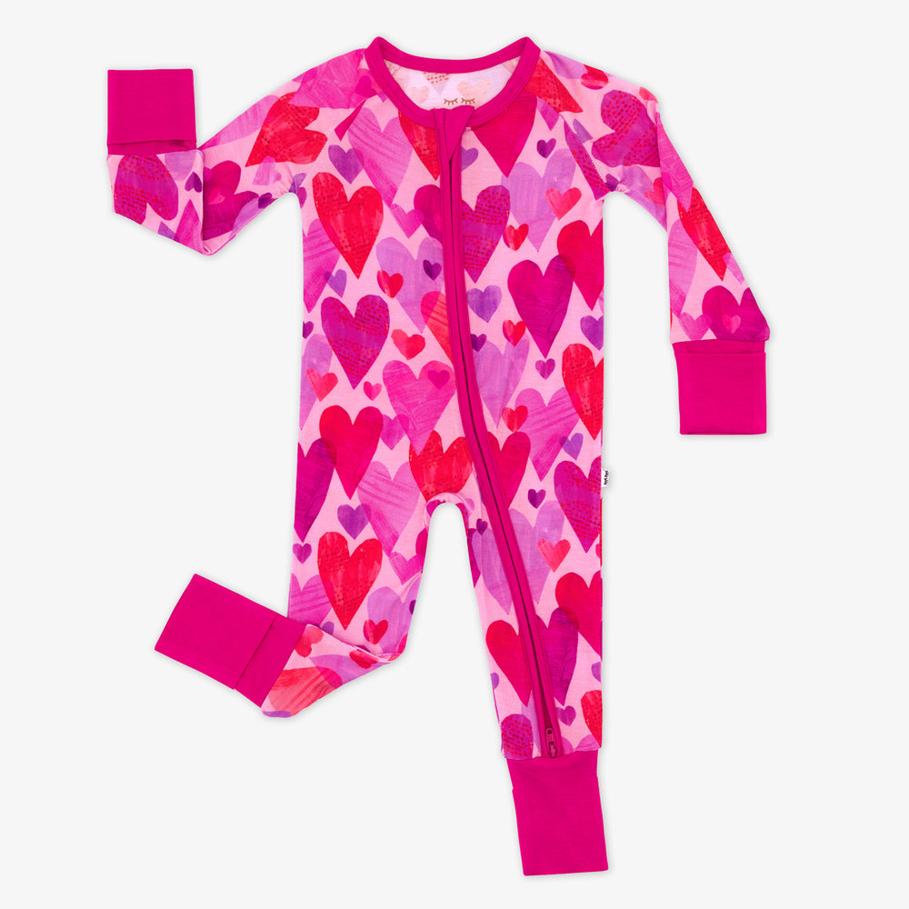 Flat lay of Pink Hearts & Crafts zippy pajamas.