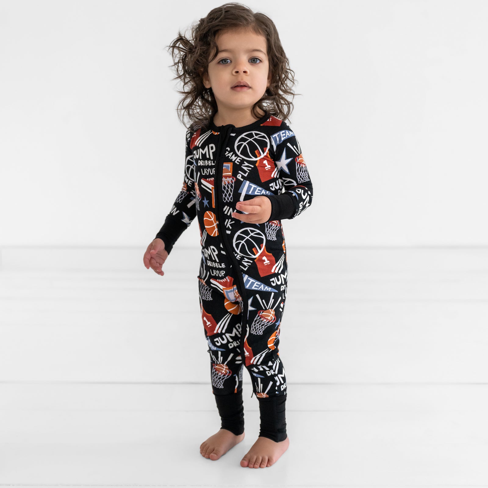 Standing child wearing Black Slam Dunk bamboo toddler pajamas