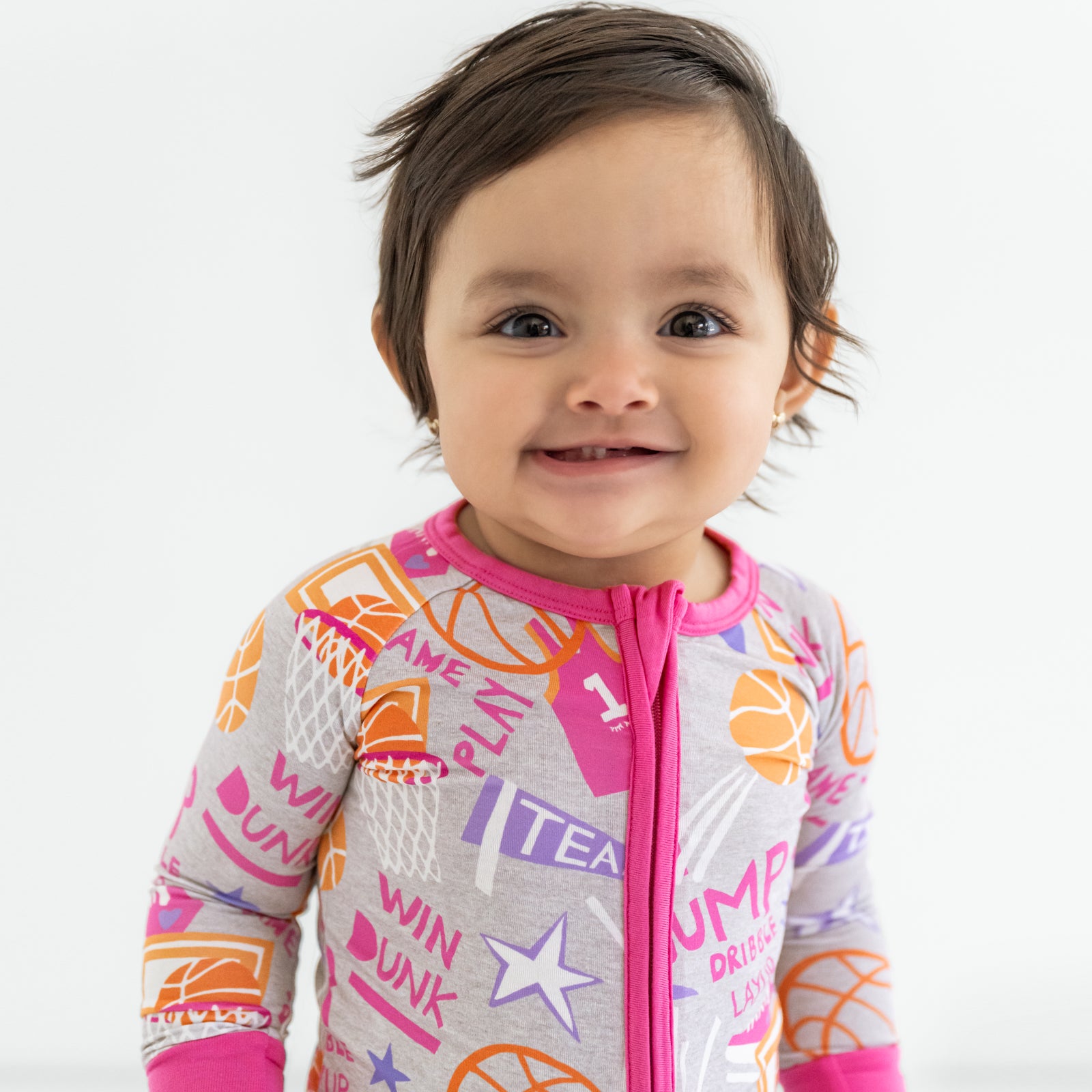 Close up of a child wearing the Pink Slam Dunk zippy