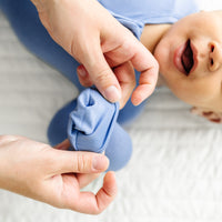 alternate image of a mother folding over a mitten cuff on their child. Child is wearing a Slate Blue zippy