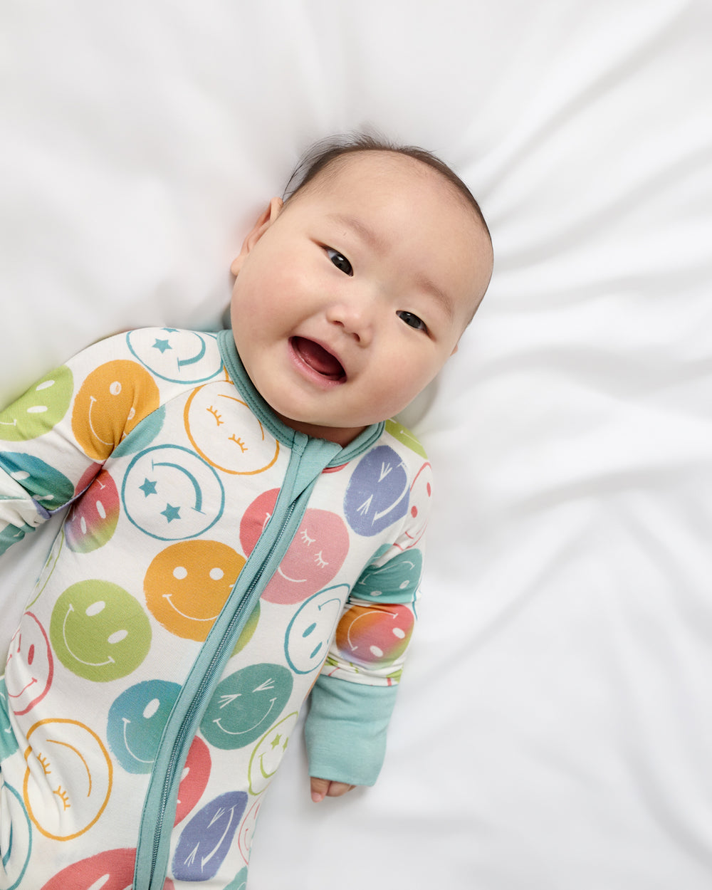 Close up of baby wearing the Positive Vibes Zippy
