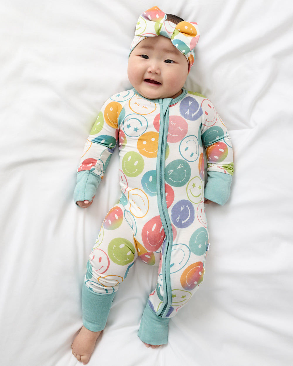 Aerial view of baby wearing the Positive Vibes Zippy and Headband