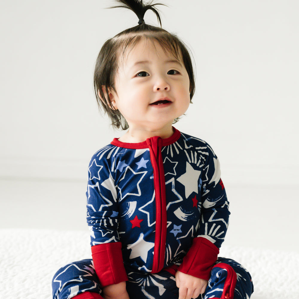 Image of a child sitting wearing a Star Spangled zippy