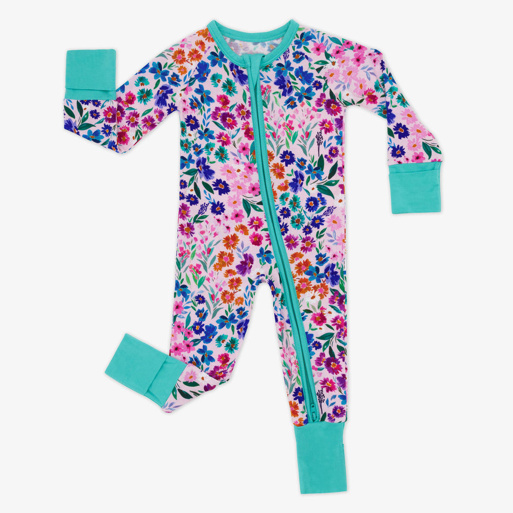 Flat lay image of a child wearing a Sweet Pea Floral zippy