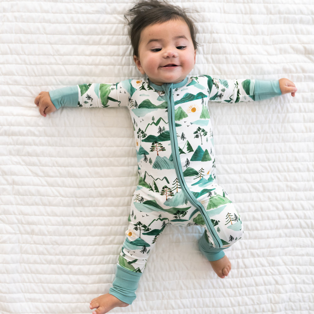 Alternate image of a child laying on a bed wearing a Mountain Mist zippy