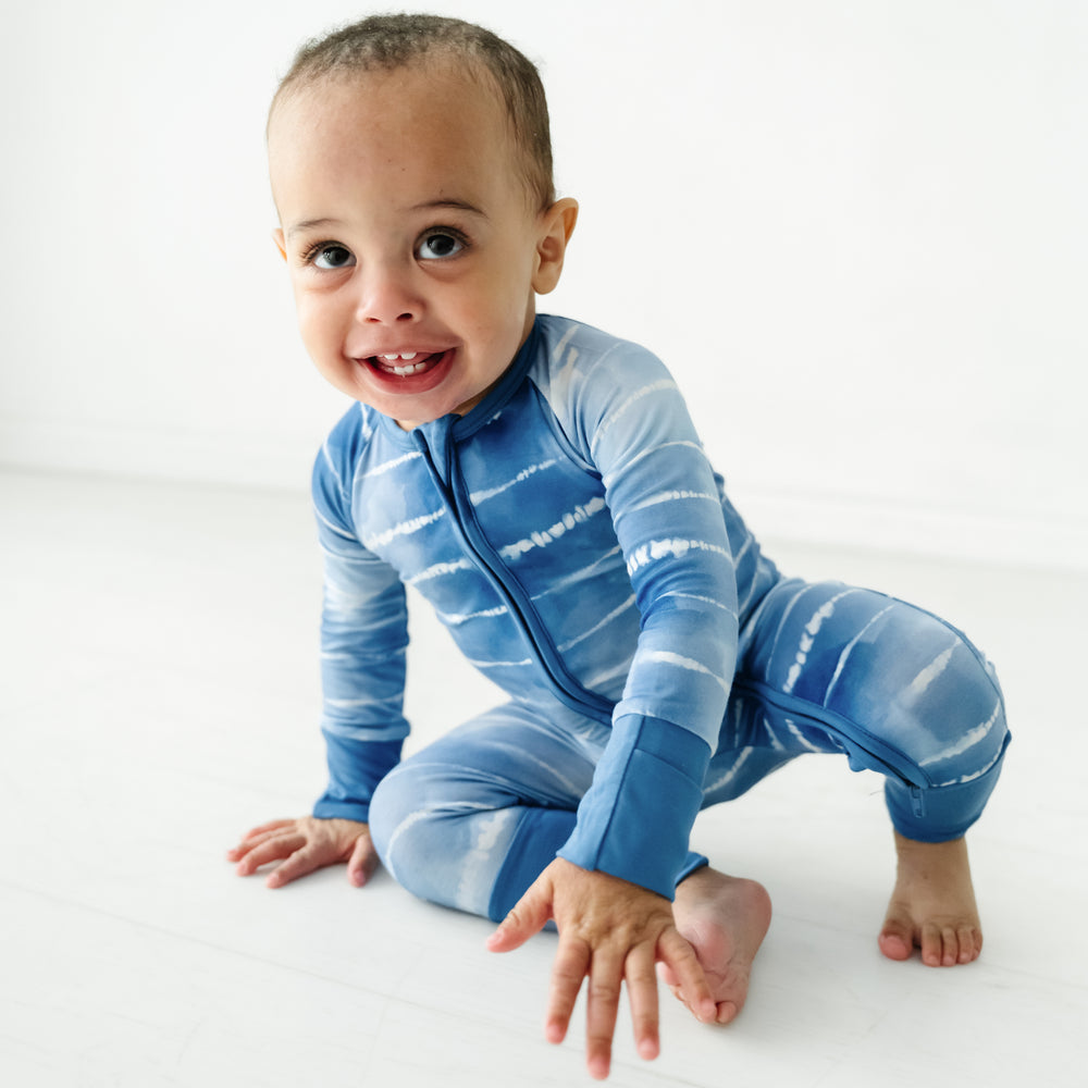 Alternate image of a child sitting on the ground wearing a Blue Tie Dye Dreams zippy