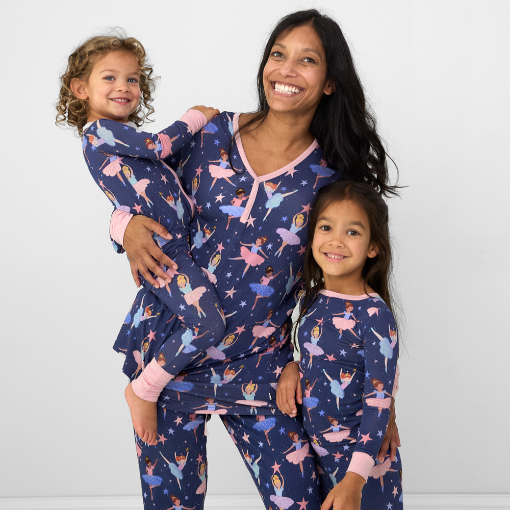 Mother and her two children wearing matching Twilight Ballet pjs in women's top and bottoms, and children's zippy and two piece styles